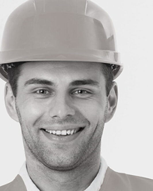 smiling-construction-engineer-posing-with-arms-crossed smiling-construction-engineer-posing-with-arms-crossed